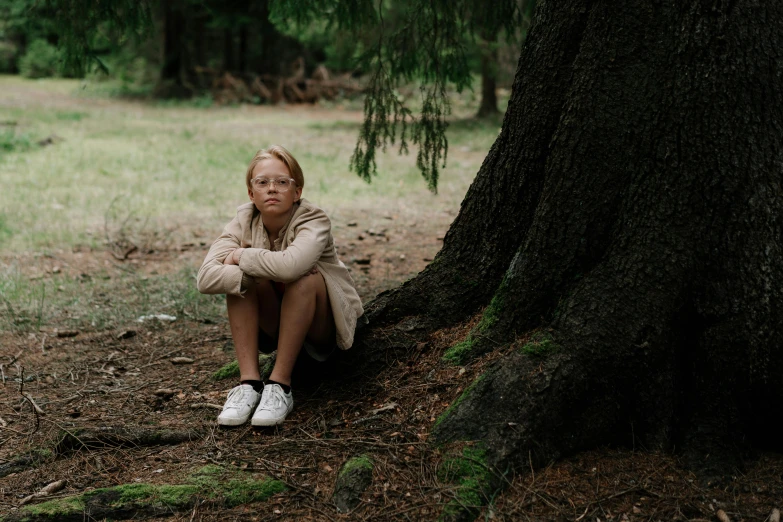 a little girl sitting on the ground next to a tree, by Attila Meszlenyi, pexels contest winner, greta thunberg, teenage girl, sad man, high quality photo