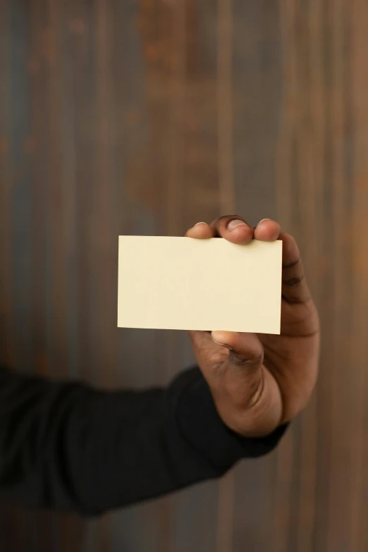 a man holding a blank business card in his hand, by Sven Erixson, unsplash, renaissance, brown and cream color scheme, any racial background, 15081959 21121991 01012000 4k