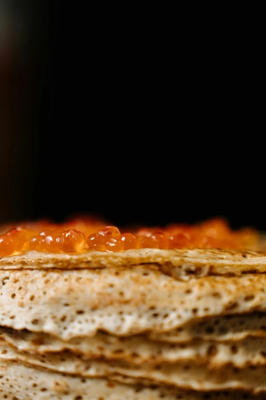 a stack of pancakes sitting on top of a table, by Dietmar Damerau, unsplash, renaissance, an island made of red caviar, close - up profile, brood spreading, tilt and orange