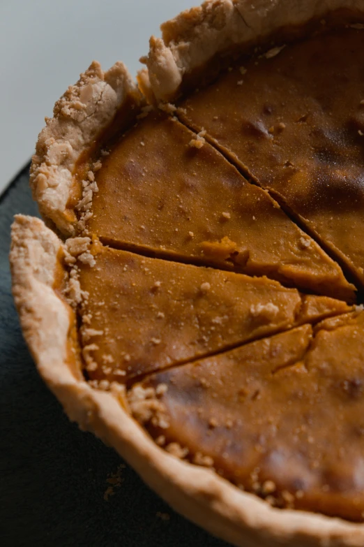 a pie with a slice taken out of it, pumpkin, shot on sony a 7, frontal close up, thumbnail