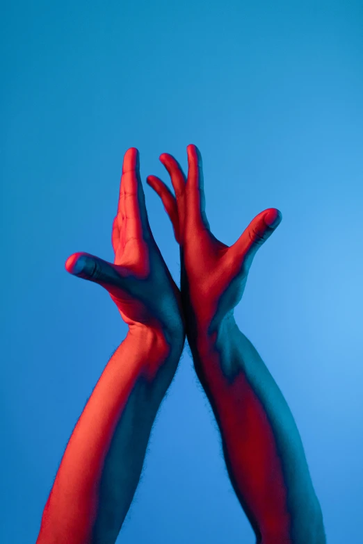 a person with their hands painted red and blue, an album cover, unsplash, synchromism, 3/4 view from below, two arms that have sharp claws, lpoty, flume