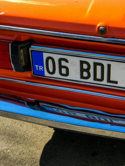 a close up of a license plate on a car, by Kristian Zahrtmann, orange body, bulli, lada, 🚿🗝📝