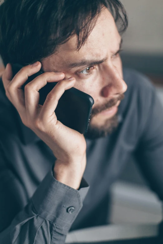 a man sitting at a table talking on a cell phone, worried, promo image, 8, multiple stories