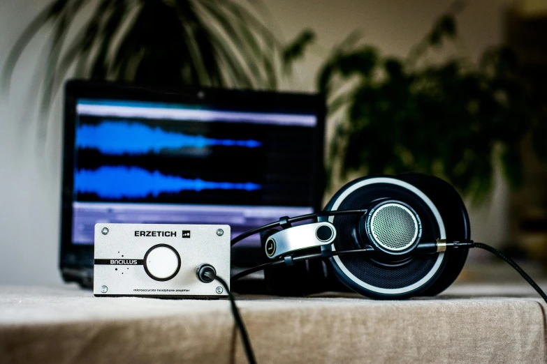 a pair of headphones sitting on top of a table, an album cover, unsplash, analytical art, monitor, sennheiser, ((zerator)), luxury equipment