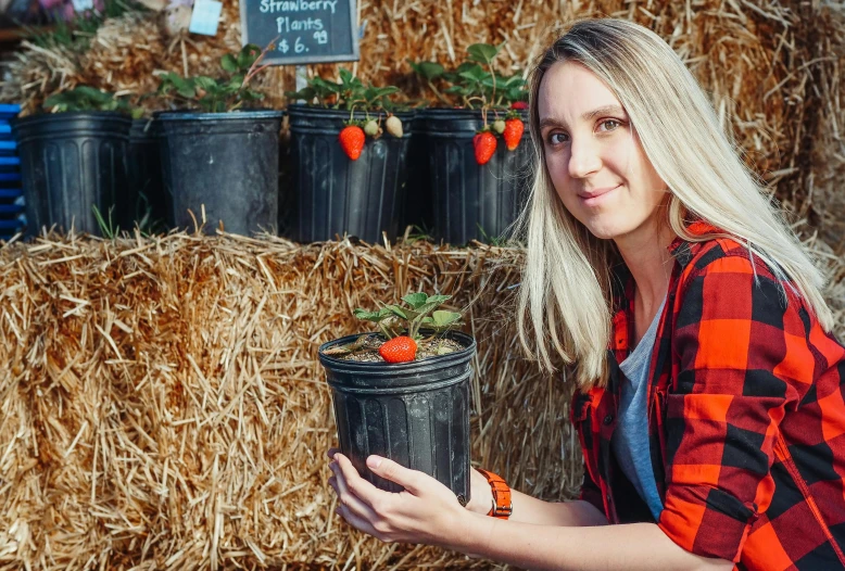 a woman holding a bucket full of strawberries, pexels contest winner, roots and hay coat, avatar image, no cropping, close up image