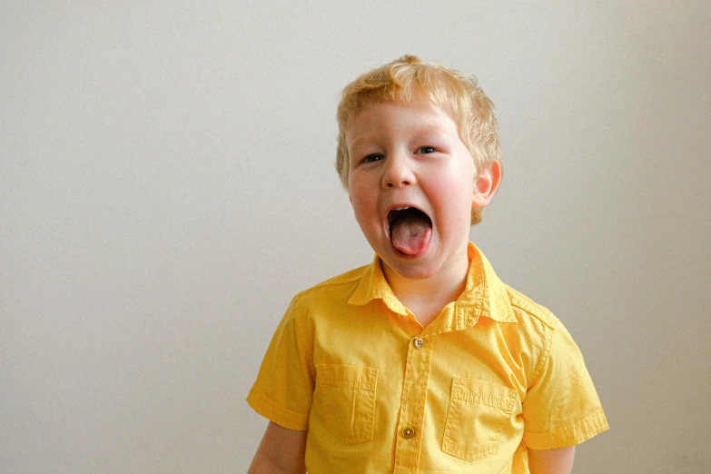 a little boy that is standing up with his mouth open, pexels, yellow clothes, someone is screaming, gif, a blond