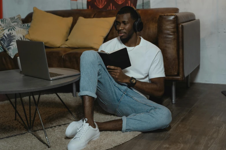 a man sitting on the floor reading a book, an album cover, pexels contest winner, happening, gaming headset, black man, 15081959 21121991 01012000 4k, wearing casual clothes