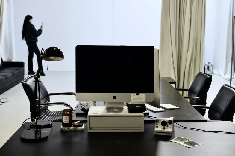 a computer monitor sitting on top of a wooden desk, inspired by Marina Abramović, curated collection, dieter rams, studio camera, white