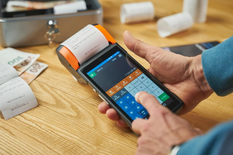 a close up of a person using a cell phone, ergodox, medical supplies, cash register, name is tripmachine