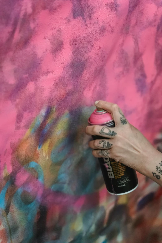 a close up of a person holding a spray can, an airbrush painting, by artist, trending on pexels, action painting, dayglo pink, lesbian art, concentrated, 144x144 canvas