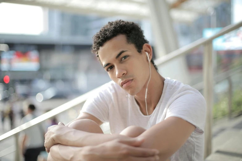 a close up of a person with headphones on, pexels, happening, lean man with light tan skin, model posing, mixed race, waiting