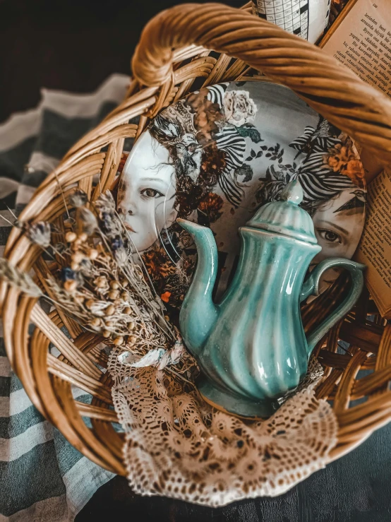 a basket filled with books and a teapot, a still life, pexels contest winner, arts and crafts movement, geisha mask, teal aesthetic, alphonse mucha 8 k, made of dried flowers