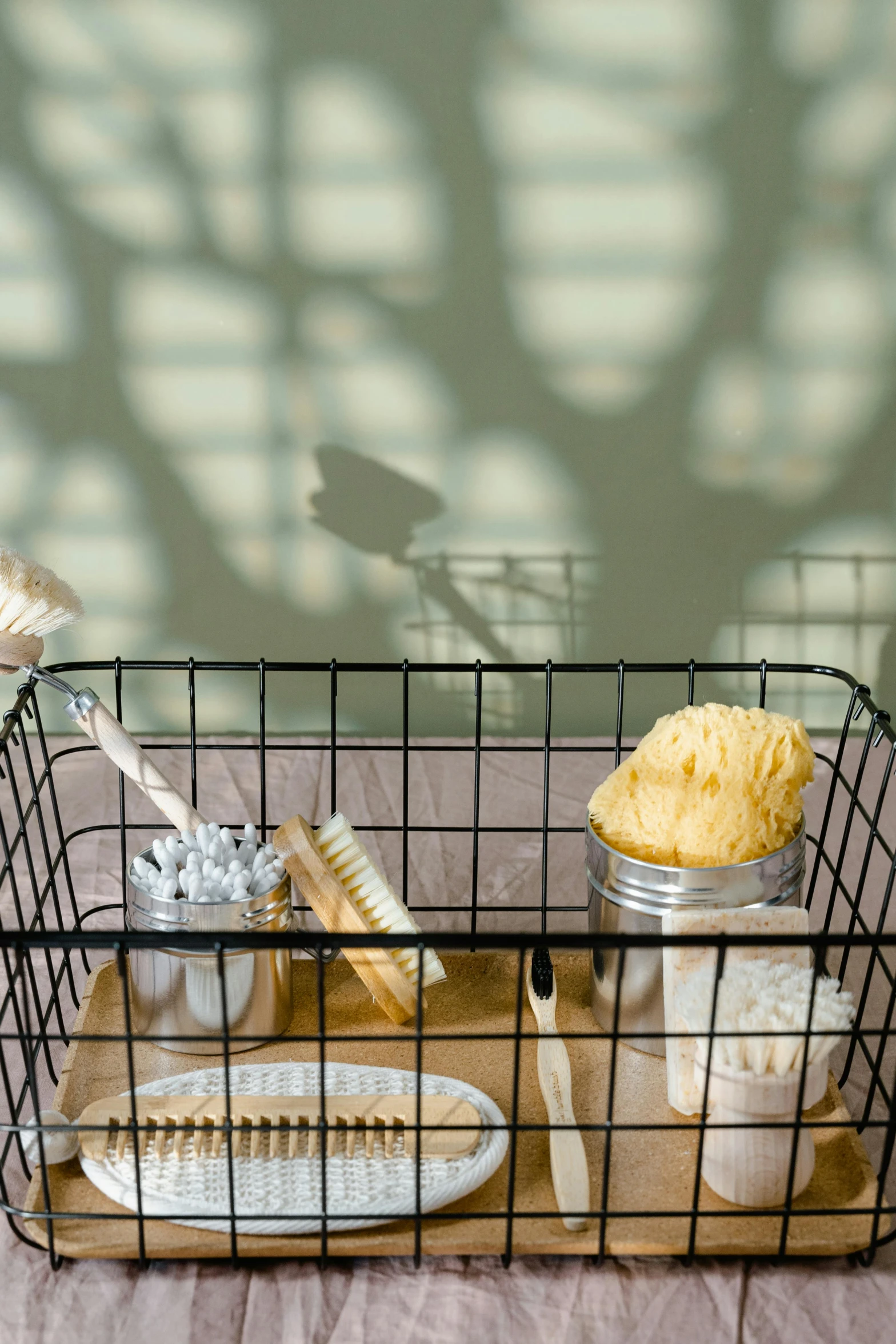 a basket filled with items sitting on top of a bed, grid, in the sun, sink, dry brushing