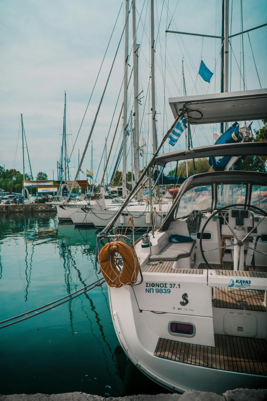 a number of boats in a body of water, a picture, pexels contest winner, stern like athena, docked at harbor, a ragdoll cat windsurfing, 3/4 front view