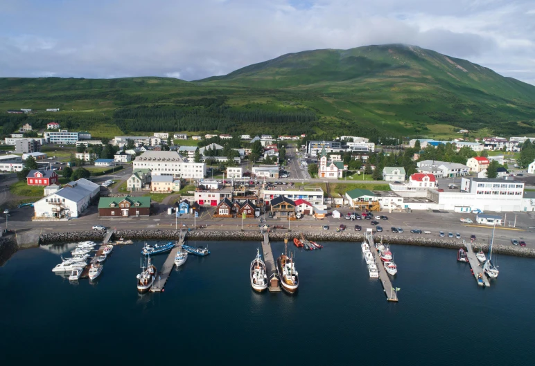 a harbor filled with lots of boats next to a mountain, by Þórarinn B. Þorláksson, pexels contest winner, dau-al-set, drone footage, square, terminal, eva elfie