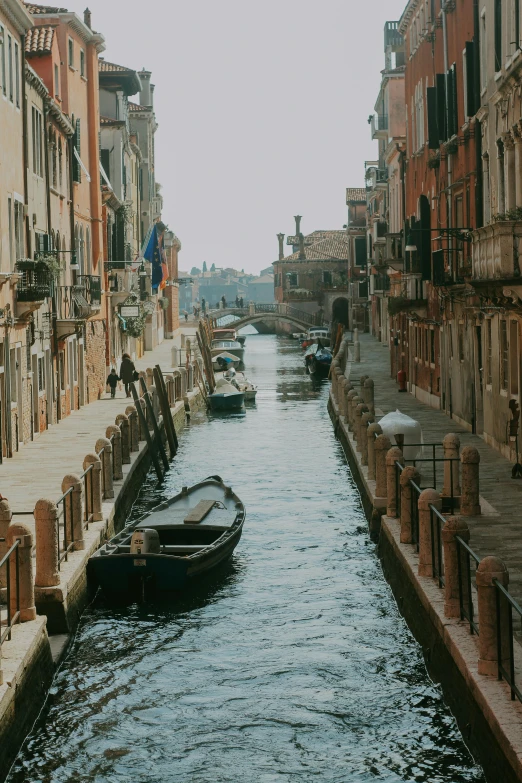 a canal filled with lots of boats next to tall buildings, pexels contest winner, renaissance, burnt sienna and venetian red, shady alleys, distant full body view, uploaded