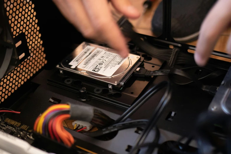 a person removing a hard drive from a computer, a computer rendering, by Sam Black, unsplash, fan favorite, full body close-up shot, gaming pc case, restoration