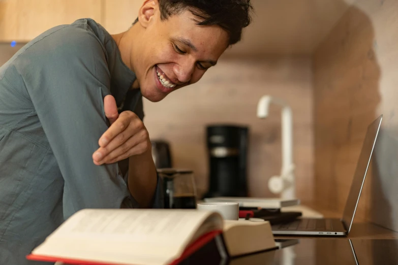 a man standing in front of a laptop giving a thumbs up, a portrait, by Jan Tengnagel, pexels contest winner, reading a book, head bent back in laughter, lachlan bailey, thumbnail