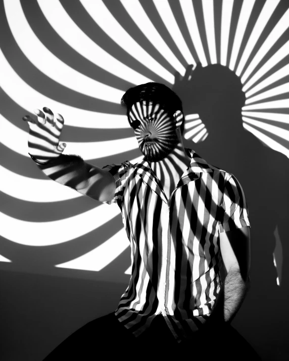 a black and white photo of a man holding a fan, op art, projection mapping, dazzle camouflage!!, stripes, photoshoot