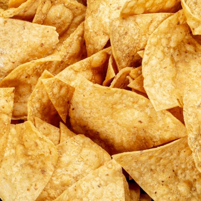 a pile of tortilla chips sitting on top of a table, 15081959 21121991 01012000 4k, background image, ultradetailedl, uncrop