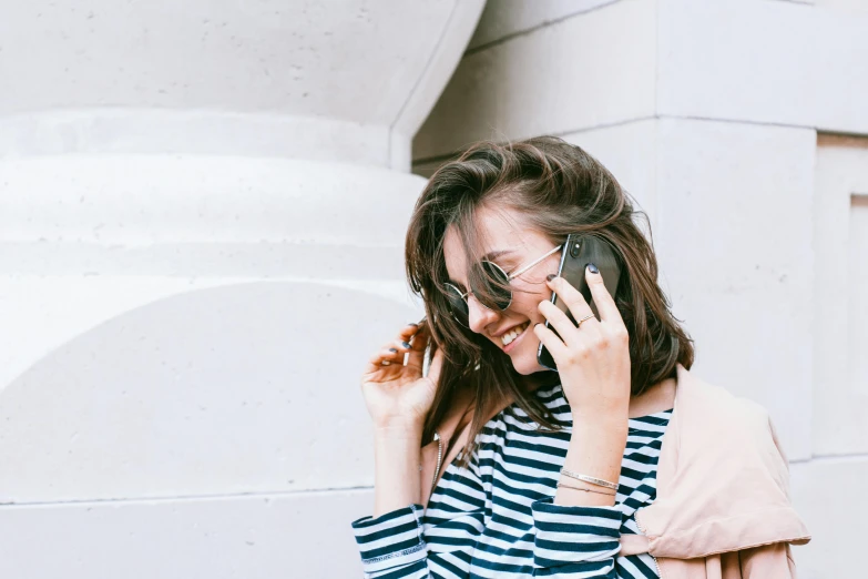 a woman with glasses talking on a cell phone, trending on pexels, romanticism, striped shirt, brunette, happy girl, rectangle