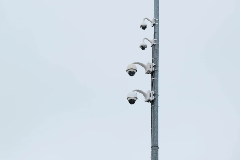 a group of surveillance cameras sitting on top of a pole, a portrait, by Jens Søndergaard, unsplash, with a white background, four, few eyeballs, automated defence platform