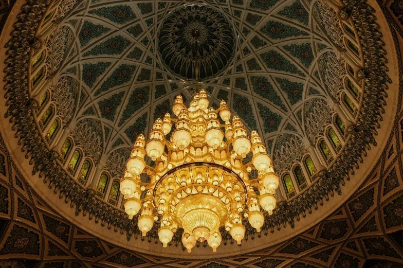 a chandelier hanging from the ceiling of a building, a mosaic, by Juergen von Huendeberg, pexels contest winner, arabesque, oman, dome of wonders, sculpture made of gold, good lighted photo