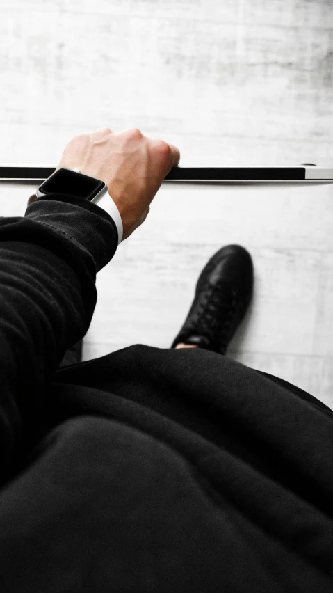 a person standing in front of a laptop computer, a black and white photo, trending on unsplash, modernism, formal black suit. detailed, clutching a sword, photo taken from above, black shoes