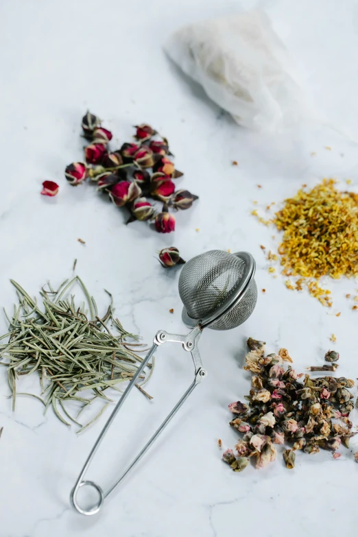 a table topped with lots of different types of tea, a still life, trending on pexels, process art, made of dried flowers, stainless steel, grey, bath