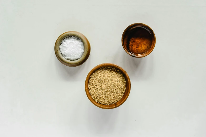 a couple of bowls sitting on top of a table, food particles, detailed product image, yeast, salt shaker