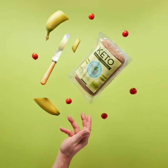 a person throwing a bag of food into the air, raspberry banana color, avocado, kidmo, holds a small knife in hand