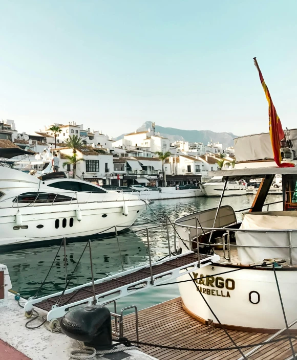 a number of boats in a body of water, by Julia Pishtar, pexels contest winner, marbella, docked at harbor, white buildings, thumbnail