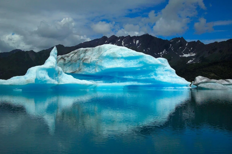 a large iceberg floating on top of a lake, by Alison Geissler, pexels contest winner, fan favorite, cold colors, alaska, mountains of ice cream