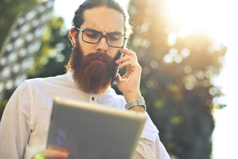 a man with a beard talking on a cell phone, pexels, laptop, thumbnail, hr ginger, dynamic scene