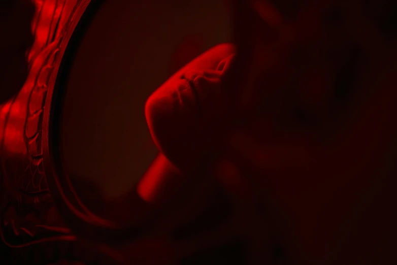 a person taking a picture of themselves in a mirror, inspired by Elsa Bleda, pexels contest winner, digital art, blood red cresent moon, hibernation capsule close-up, volumetric lighting. red, shot on canon eos r5