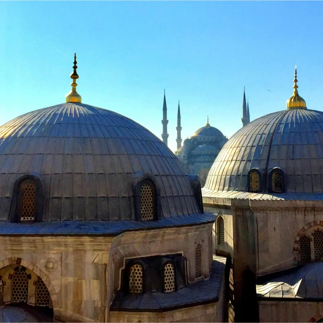 a couple of domes sitting on top of a building, inspired by Altoon Sultan, pexels contest winner, hurufiyya, sweeping vista, ottoman empire, 256x256, photo taken with an iphone