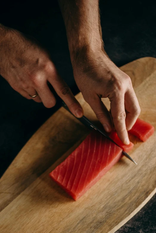 a person cutting up a piece of fish on a cutting board, umami, highly upvoted, sculpting, instruction