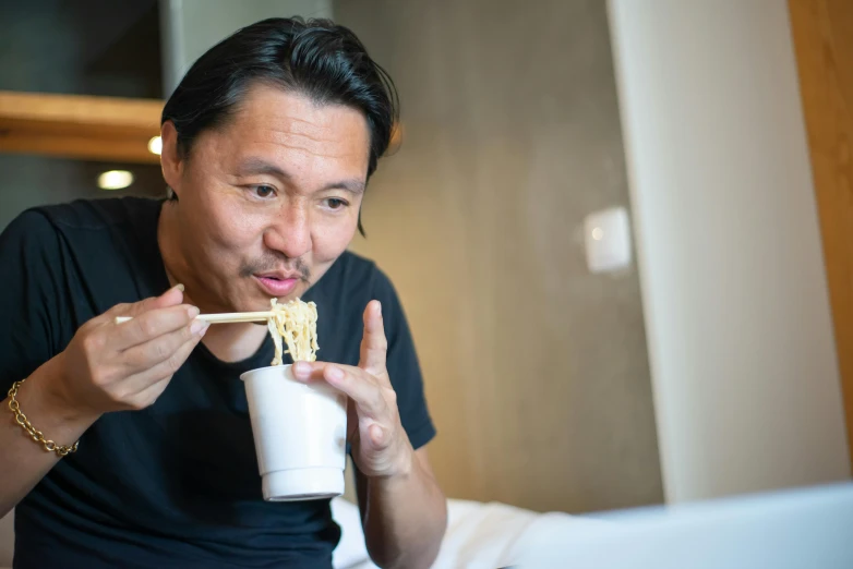 a man eating noodles with chopsticks in front of a laptop, a portrait, inspired by Shigeru Aoki, pexels contest winner, shin hanga, hotel room, avatar image, drinking boba tea, like andy lau