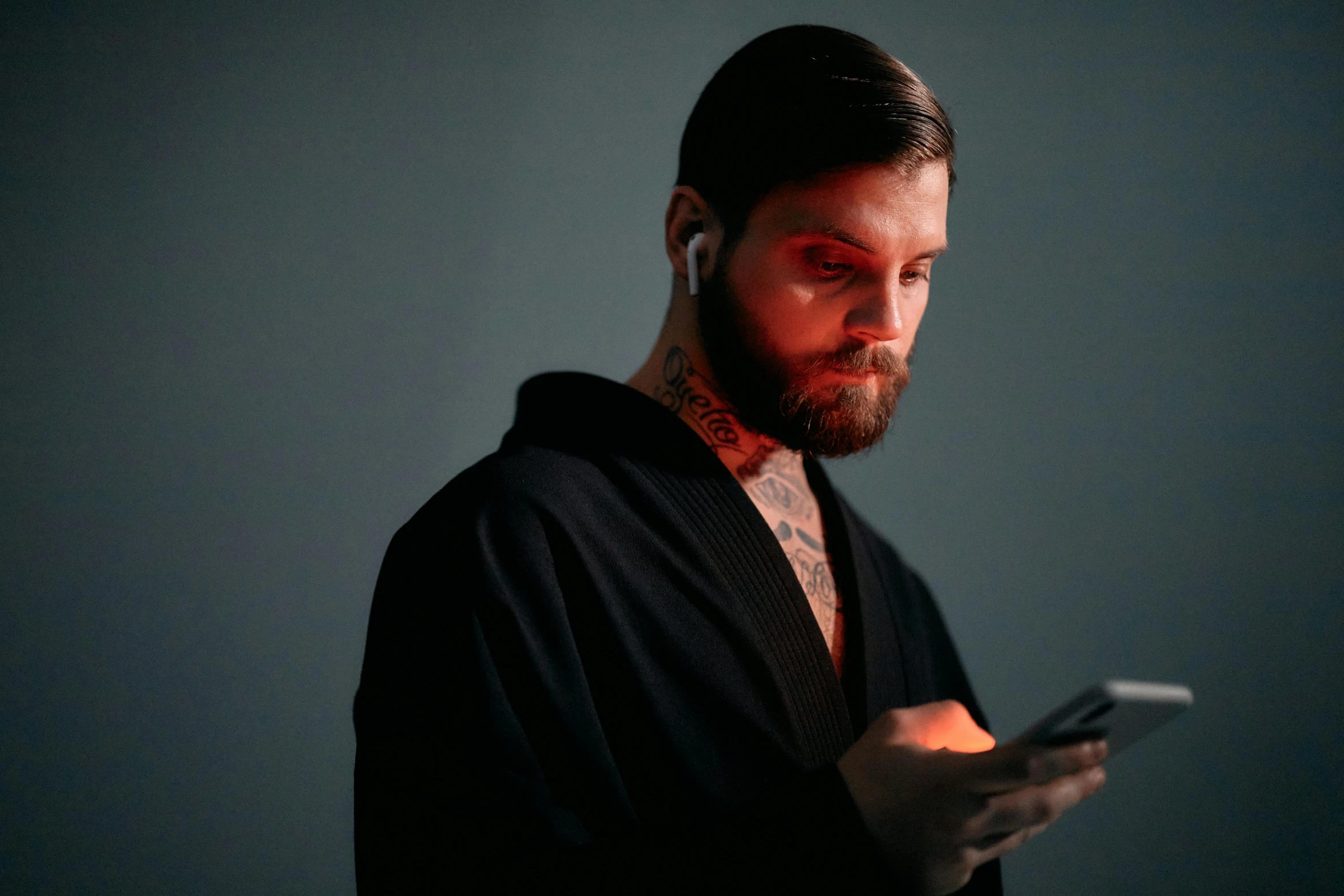a man with a beard using a cell phone, a tattoo, trending on pexels, hyperrealism, wearing black sith robes, glowing, ryoji, avatar image