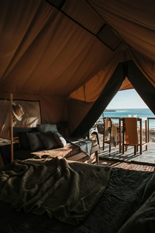 a bedroom with a view of the ocean, by Jessie Algie, unsplash contest winner, renaissance, merchant tents, brown, regular build, australia