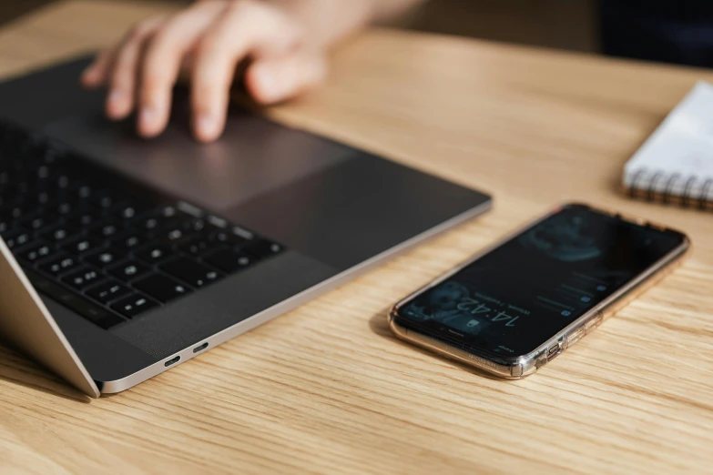 a laptop computer sitting on top of a wooden table, by Adam Marczyński, trending on pexels, holding a very advance phone, thumbnail, background image, it specialist