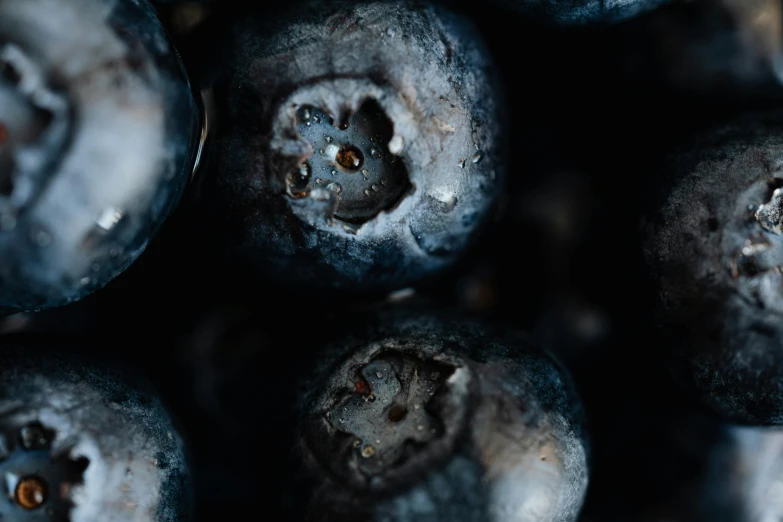 a close up of a bunch of blueberries, a macro photograph, by Adam Marczyński, pexels contest winner, hyperrealism, dark, made of food, background image, spooky photo