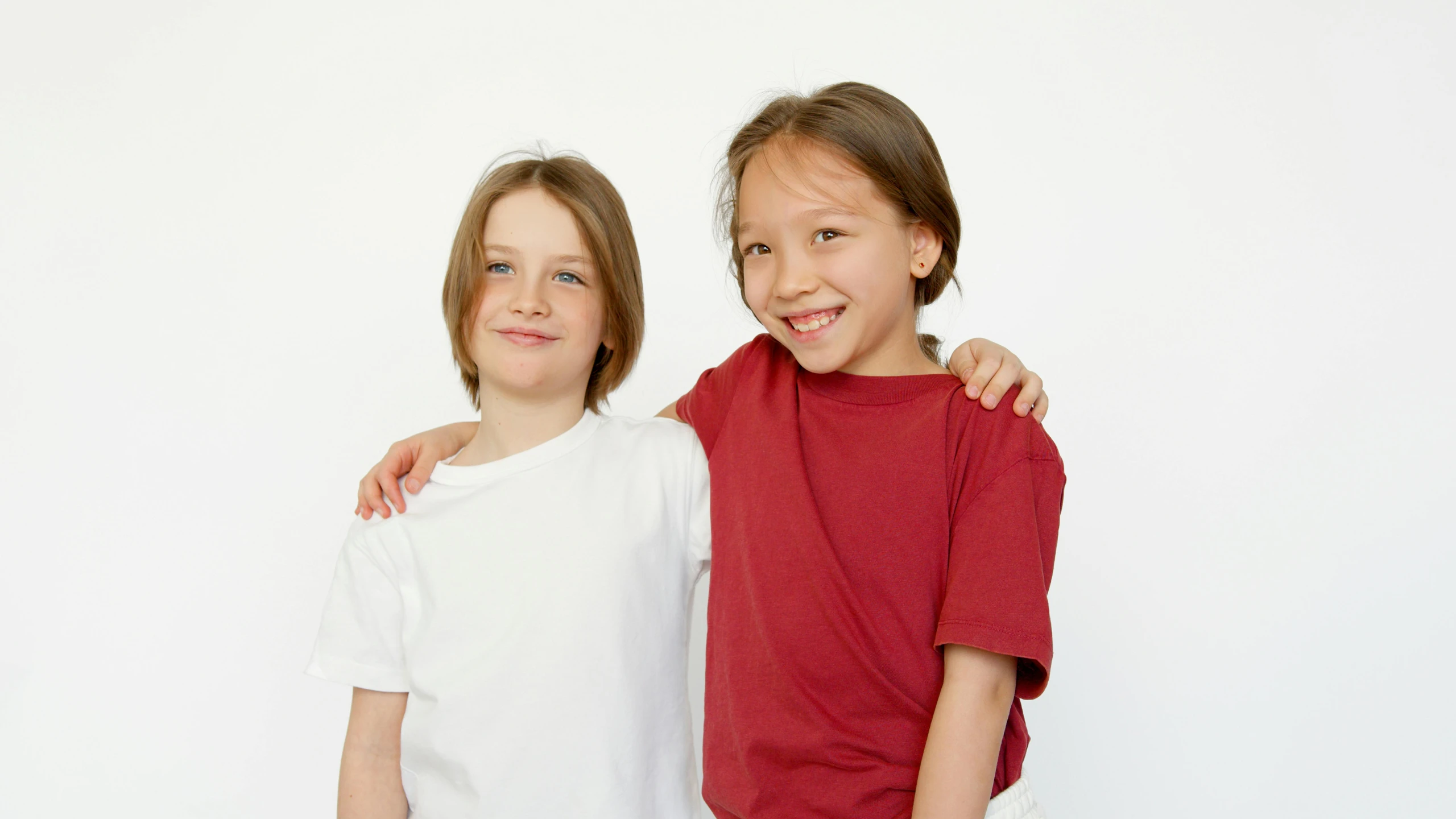 a couple of young girls standing next to each other, wearing shirts, boys, official product photo, medium head to shoulder shot