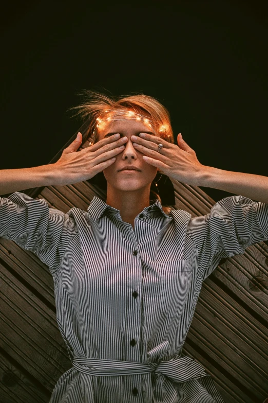 a woman covering her eyes with her hands, by Adam Marczyński, pexels contest winner, complex lights, androgynous person, a blond, creating an optical illusion