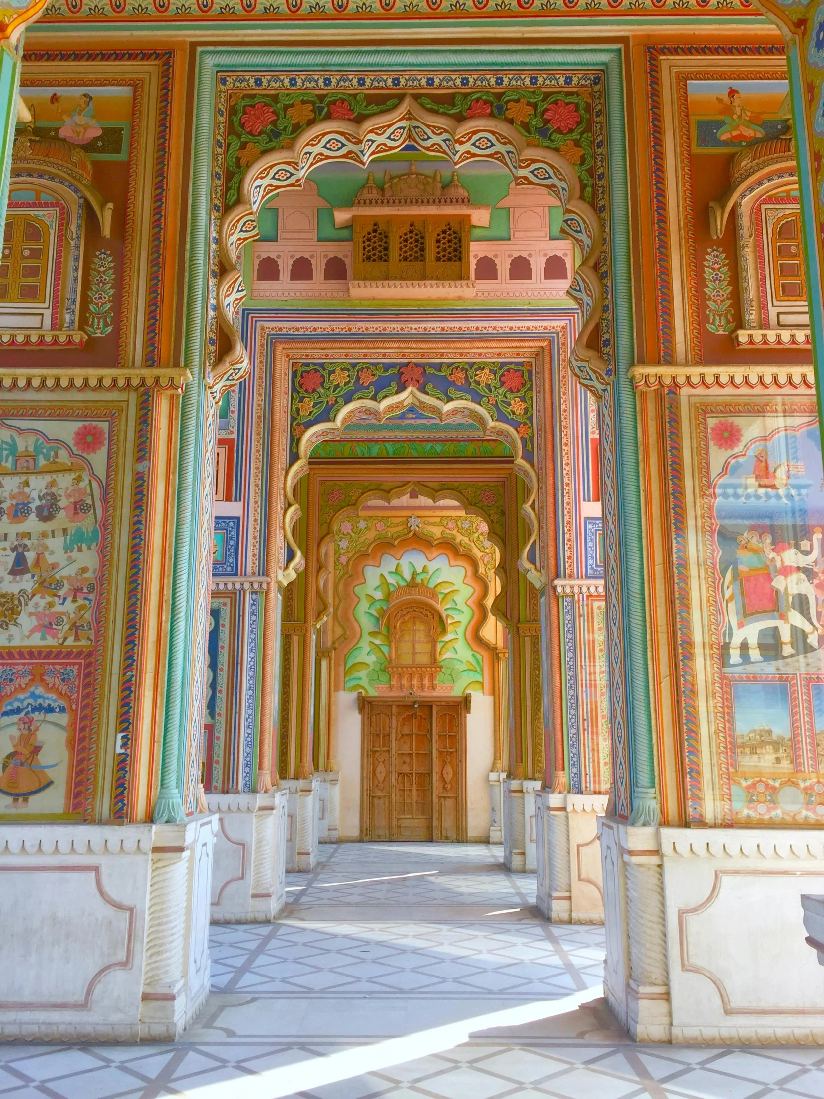 the inside of an ornately decorated building, amazing colours, huge gate, beautiful views, single floor