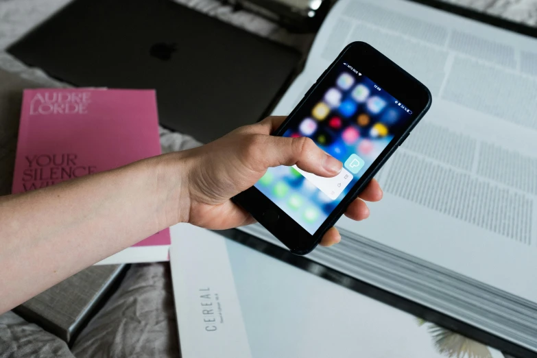 a close up of a person holding a cell phone, pexels contest winner, hand on table, with apple, document photo, thumbnail