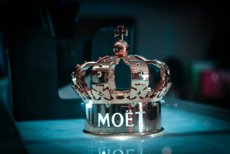 a crown sitting on top of a table, inspired by Mór Than, pexels contest winner, motel, metal body, mrbeast, ambient volumetric lighting