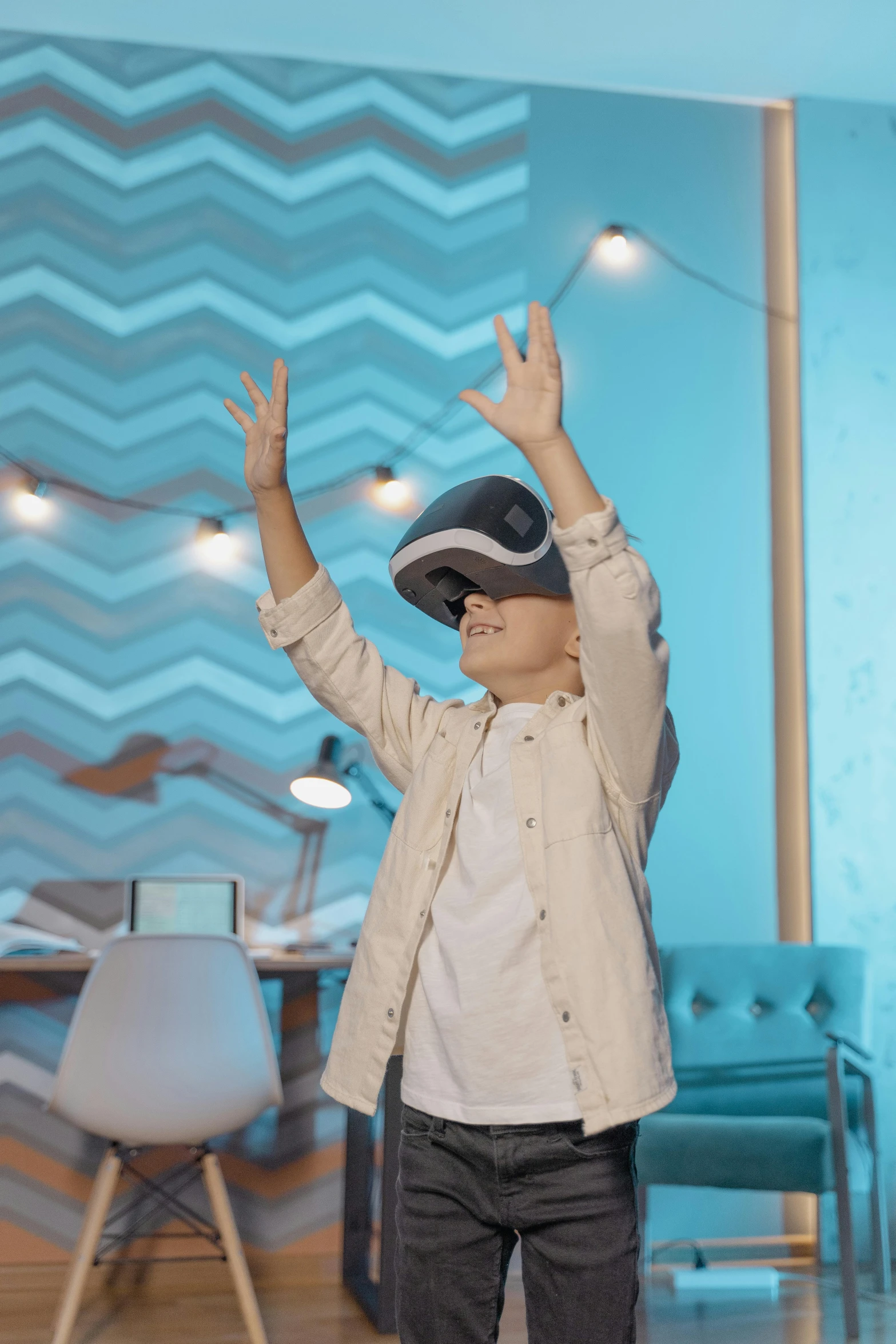 a boy wearing a virtual reality headset in a living room, a hologram, trending on pexels, interactive art, waving, wearing a round helmet, school class, halo above head