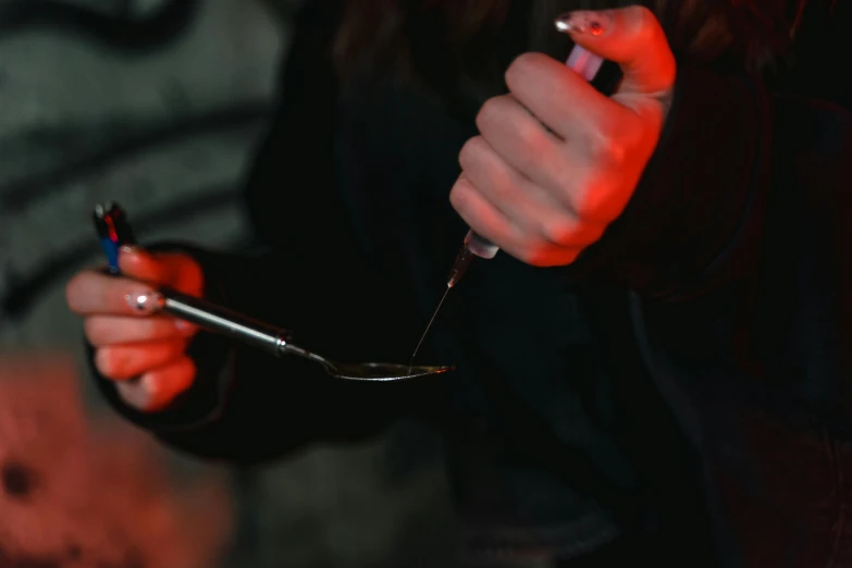 a close up of a person holding a pair of scissors, drugs, group of people in a dark room, profile image, spoon placed