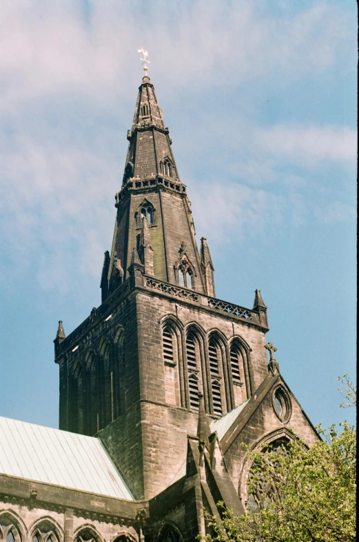 an old church with a steeple against a blue sky, inspired by John Rhind, paisley, photo 1998, up-angle view, spire